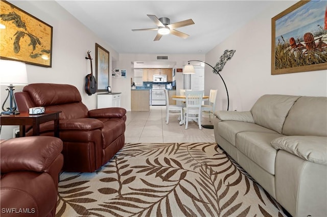 tiled living room with ceiling fan