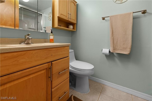 bathroom featuring tile patterned flooring, vanity, and toilet