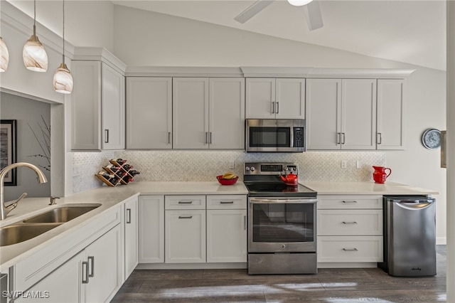 kitchen with white cabinets, sink, vaulted ceiling, dark hardwood / wood-style floors, and stainless steel appliances