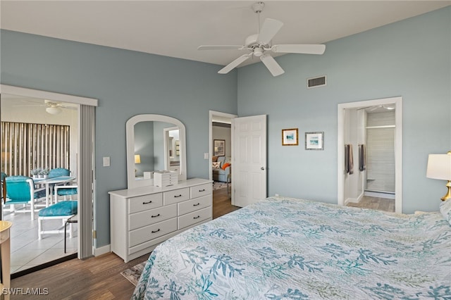 bedroom featuring ceiling fan, wood-type flooring, ensuite bathroom, and access to outside