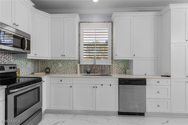 kitchen featuring white cabinets, decorative backsplash, stainless steel appliances, and sink