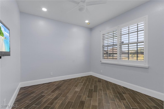 empty room with ceiling fan and dark hardwood / wood-style flooring