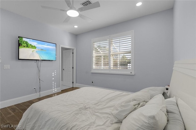 bedroom with ceiling fan and dark wood-type flooring