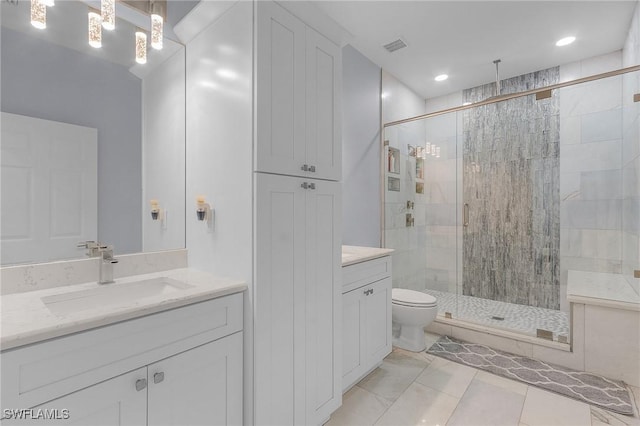 bathroom featuring tile patterned floors, vanity, toilet, and an enclosed shower