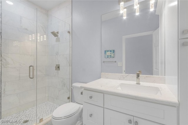 bathroom featuring vanity, an enclosed shower, and toilet