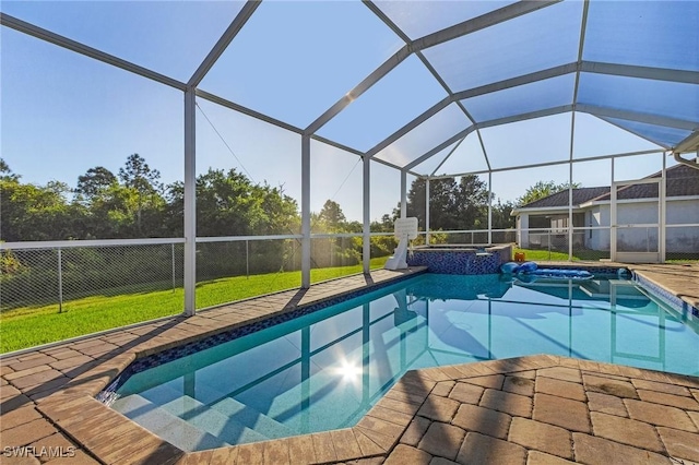 view of swimming pool with glass enclosure, an in ground hot tub, a yard, and a patio area