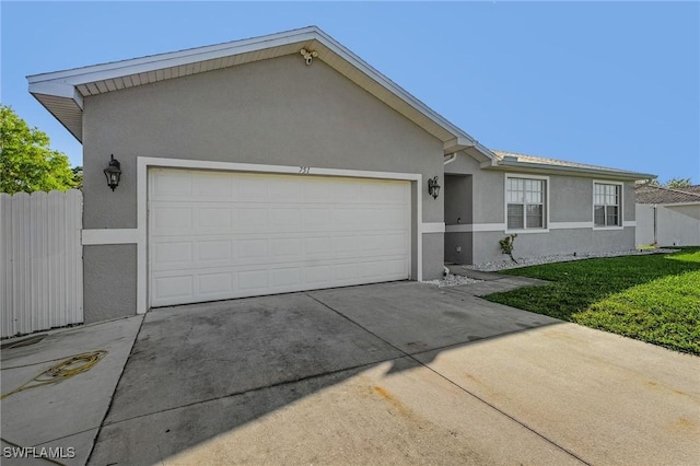 ranch-style home featuring a garage and a front lawn