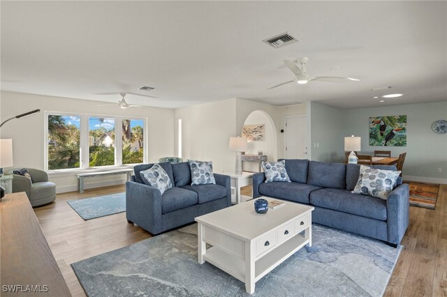 living room with ceiling fan and light hardwood / wood-style floors