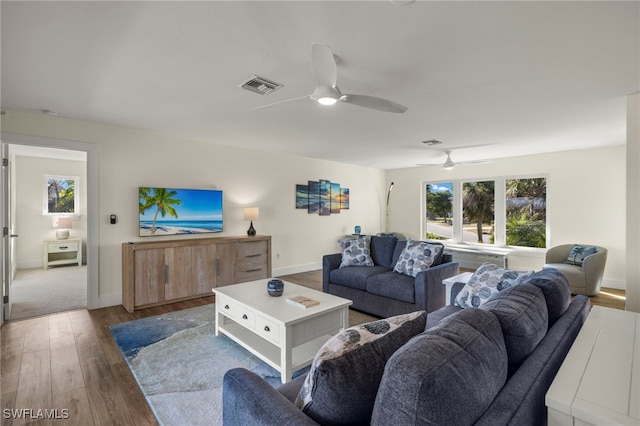 living room with wood-type flooring and ceiling fan