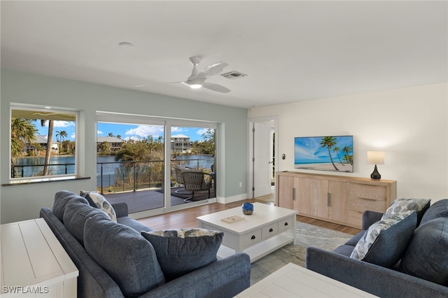 672 Durion Ct, Sanibel, FL 33957 - living area with ceiling fan, a water view, visible vents, and light wood-style floors