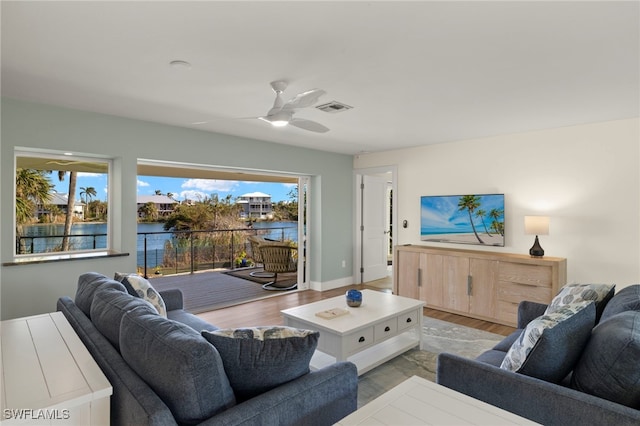 living room with light hardwood / wood-style floors and ceiling fan