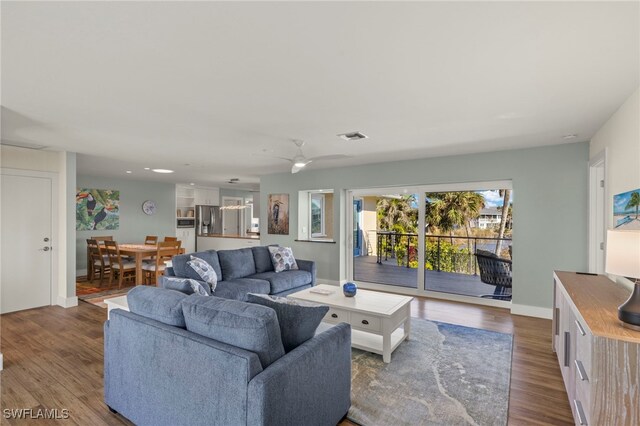 living room featuring ceiling fan and hardwood / wood-style flooring