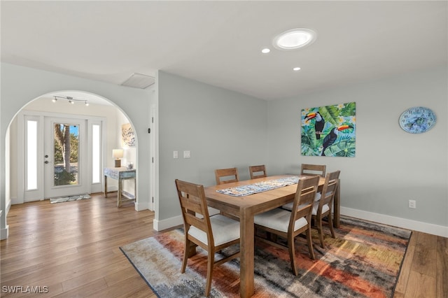 672 Durion Ct, Sanibel, FL 33957 - dining area featuring arched walkways, recessed lighting, baseboards, and wood finished floors