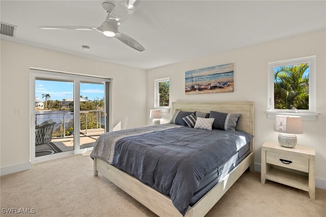 bedroom with access to outside, ceiling fan, and light carpet