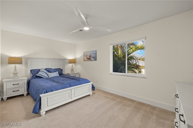 bedroom featuring light colored carpet and ceiling fan