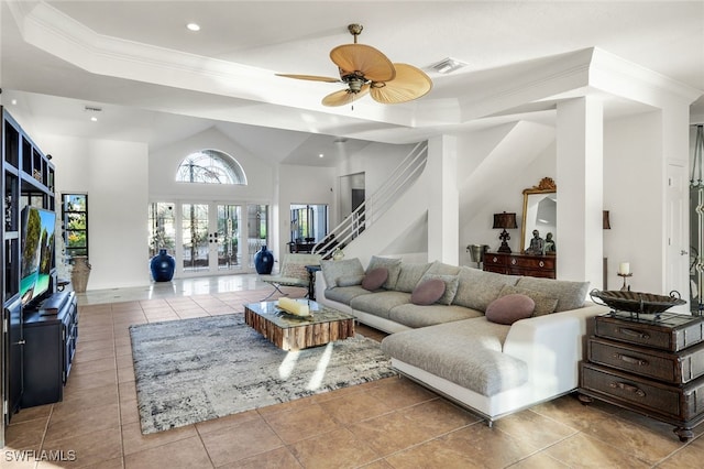 living area featuring light tile patterned floors, visible vents, french doors, a tray ceiling, and crown molding