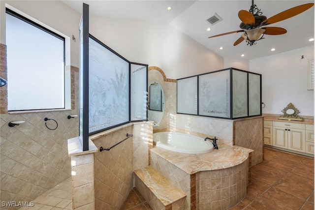 bathroom featuring visible vents, a garden tub, walk in shower, vaulted ceiling, and vanity