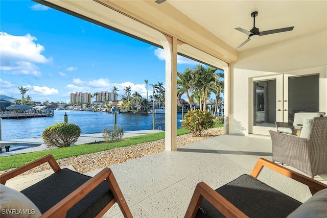 view of patio featuring a ceiling fan and a water view