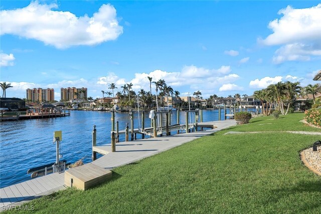 view of dock featuring a water view and a lawn