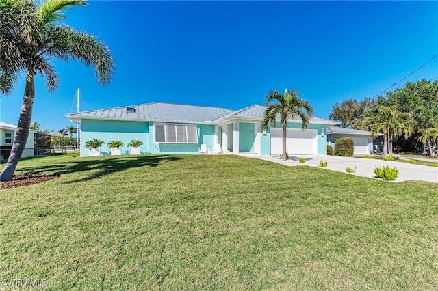 ranch-style house featuring a garage and a front lawn