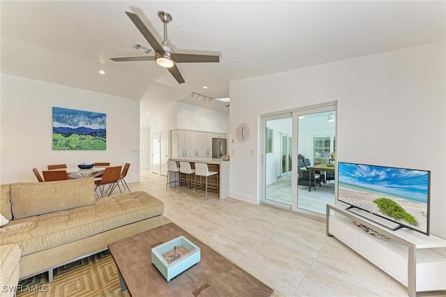 living room featuring ceiling fan and light tile patterned floors