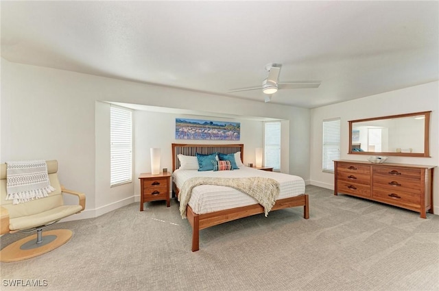 bedroom with ceiling fan and light carpet