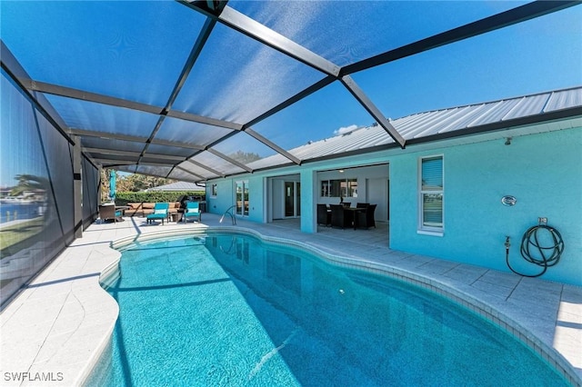 view of pool with a patio and glass enclosure