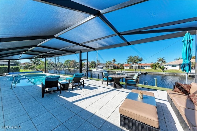 view of pool featuring a patio area, a water view, and glass enclosure