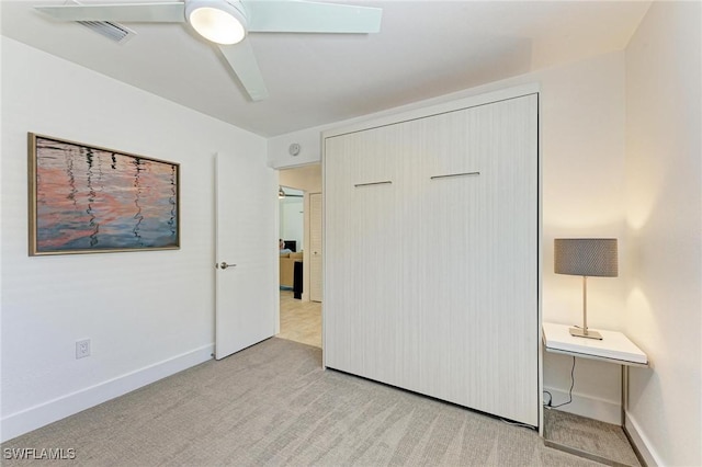 unfurnished bedroom with ceiling fan, a closet, and light colored carpet