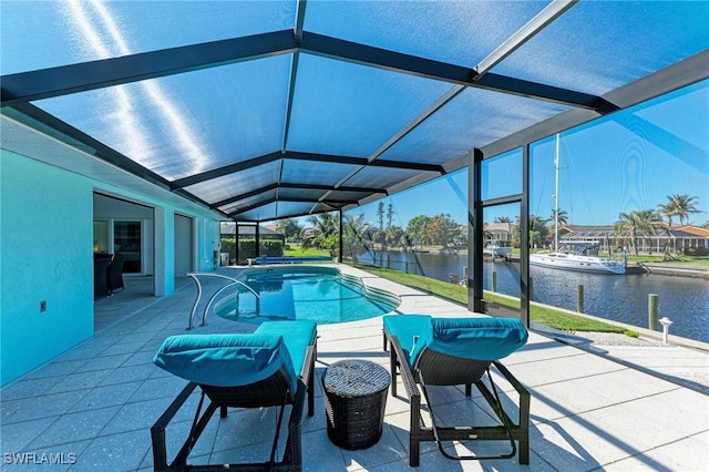 view of swimming pool with a water view, a patio area, and a lanai