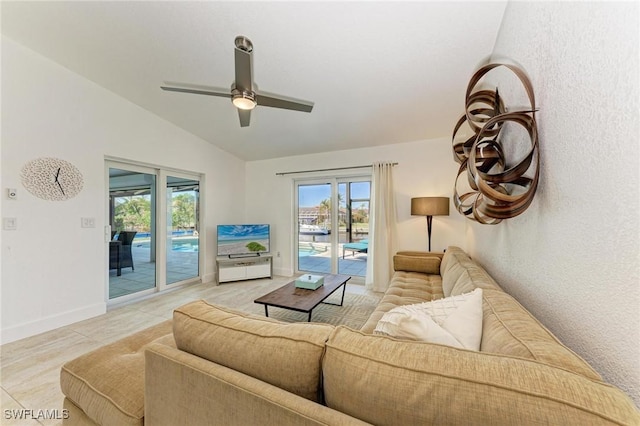 living room with vaulted ceiling, ceiling fan, and light tile patterned flooring