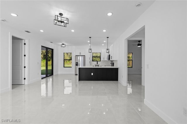 kitchen featuring white cabinetry, sink, ceiling fan, stainless steel fridge with ice dispenser, and decorative light fixtures