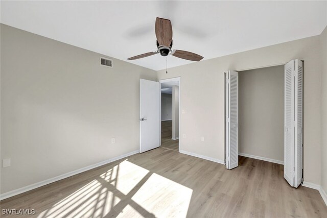 unfurnished bedroom with ceiling fan, a closet, and light hardwood / wood-style flooring