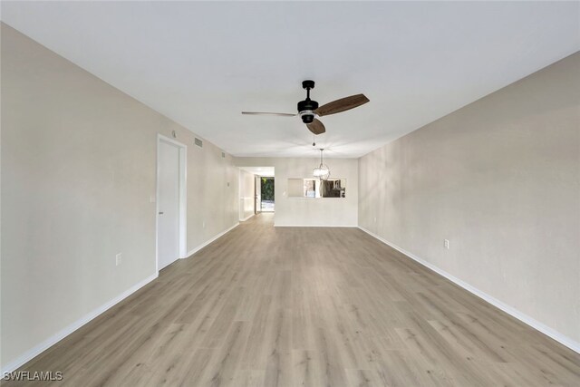 unfurnished living room featuring ceiling fan and light hardwood / wood-style flooring