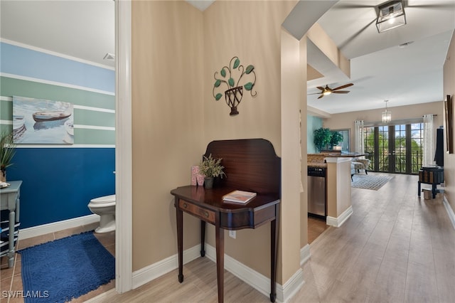 hallway featuring french doors and light wood-type flooring