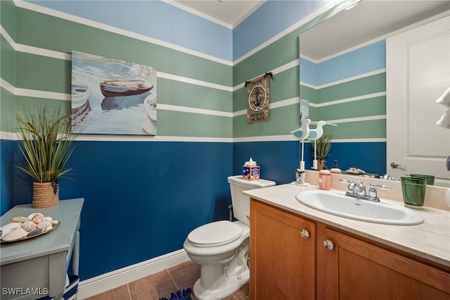 bathroom featuring toilet, tile patterned floors, baseboards, and vanity