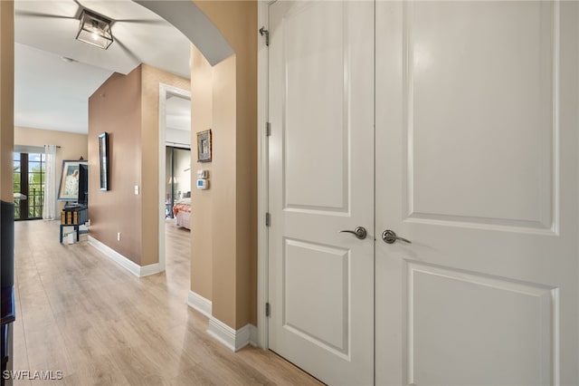 hallway with light hardwood / wood-style floors