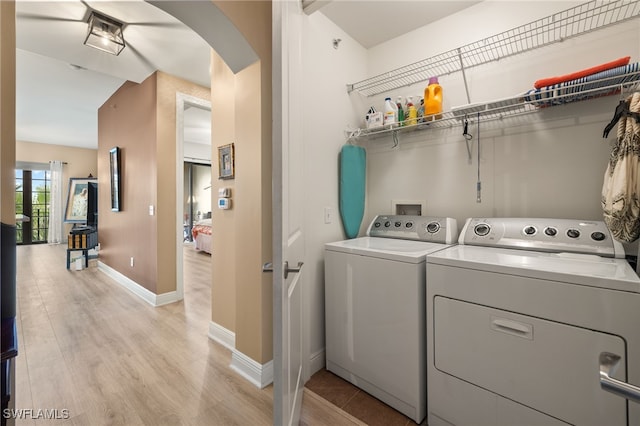 washroom featuring washing machine and dryer and light wood-type flooring