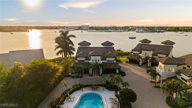 aerial view at dusk with a water view