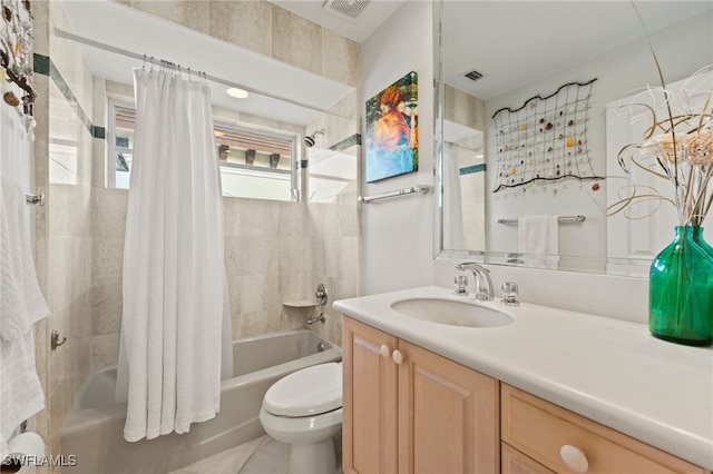 full bathroom with tile patterned floors, vanity, toilet, and shower / bath combo with shower curtain