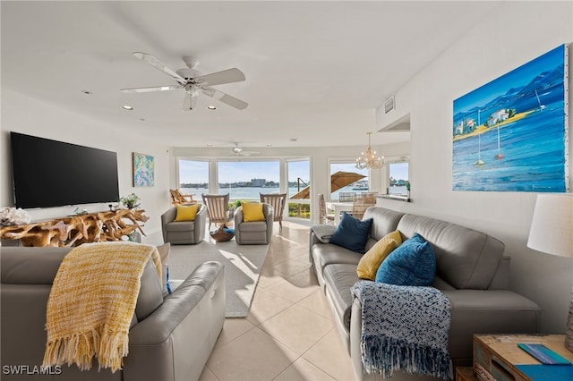 living room featuring light tile patterned floors and ceiling fan with notable chandelier