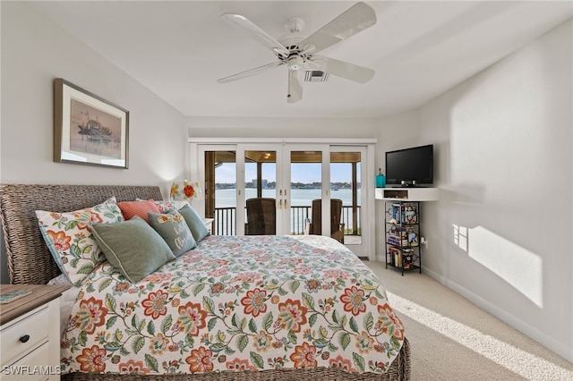 carpeted bedroom with access to outside, ceiling fan, and french doors