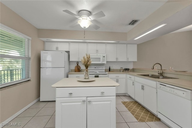 kitchen with light tile patterned flooring, sink, white cabinets, and white appliances