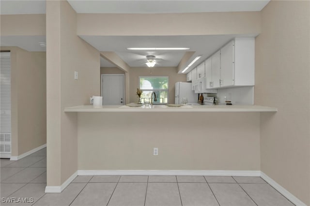 kitchen featuring ceiling fan, white cabinets, white refrigerator, and kitchen peninsula