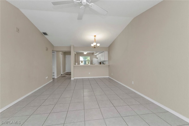 unfurnished living room featuring vaulted ceiling, light tile patterned flooring, and ceiling fan with notable chandelier