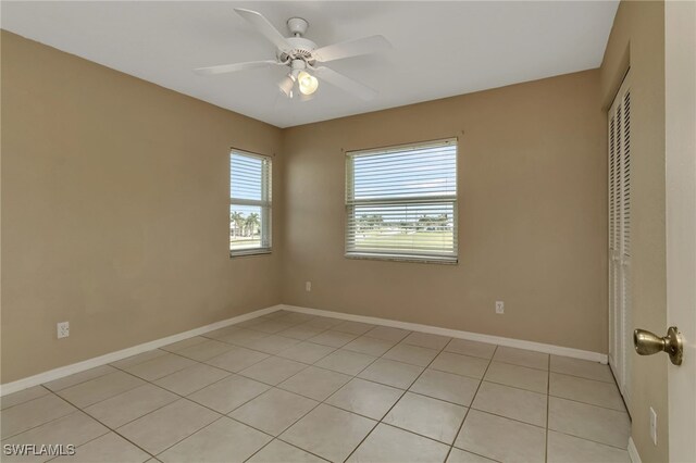 unfurnished room featuring ceiling fan and light tile patterned floors