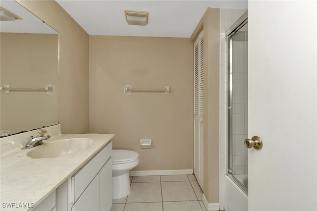 full bathroom with toilet, tile patterned floors, vanity, and shower / bath combination with glass door