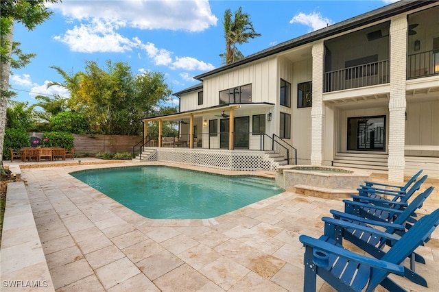 view of pool with ceiling fan, an in ground hot tub, and a patio