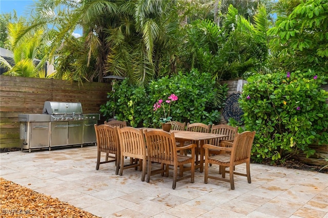 view of patio featuring area for grilling and a grill