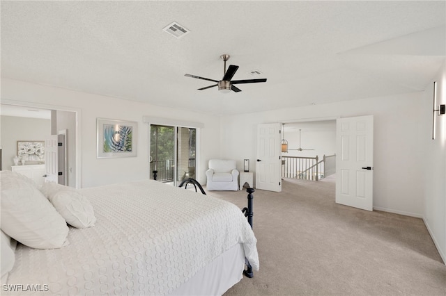 bedroom with a textured ceiling, ceiling fan, light carpet, and access to outside